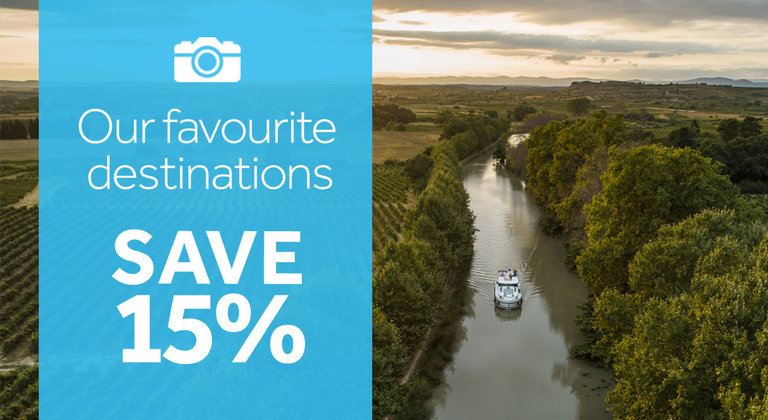 Save 15% on select European destinations in 2023. Aerial view image on a boat on a tree-lined river in the background